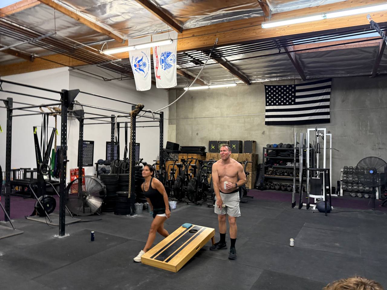 A cornhole game in full swing during the Freedom WOD social hour